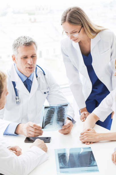 Group of doctors discuss x-ray stock photo