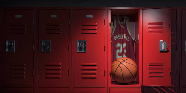 Basketball locker room with spotlight on the basketball ball and jersey in open locker. stock photo
