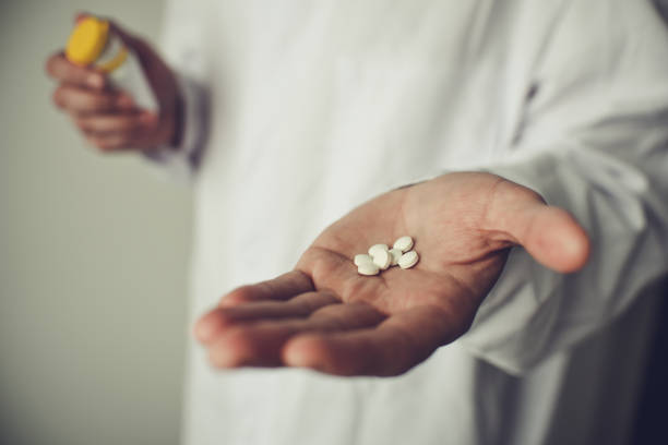 istock Pills in doctor's hand, white background 1482867182