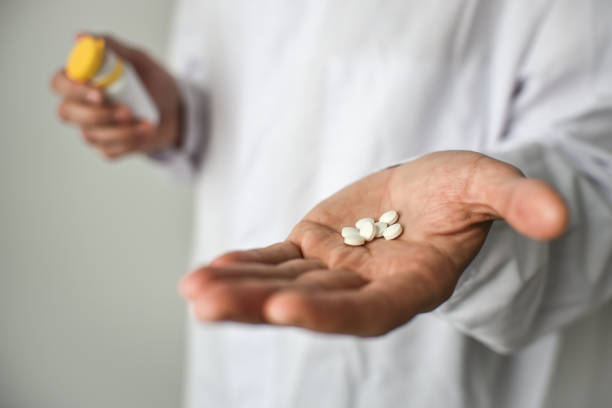 istock Pills in doctor's hand, white background 1482867188