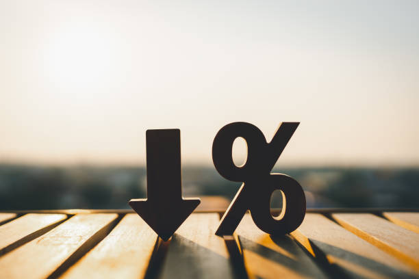 Percentage model and down arrow with evening sky Key concepts for success, methods, systems of raising or lowering Fed interest rates to correct inflation concepts. stock photo