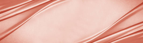 istock Peach pink rose silk satin. Draped fabric. Light pale coral luxury background. Flat lay, top view table. 1482869846