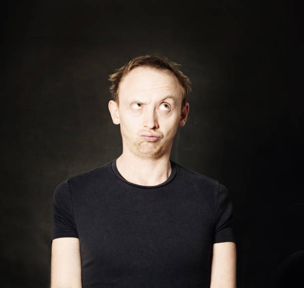 istock Pensive man on balck background. Choice concept 1482870861
