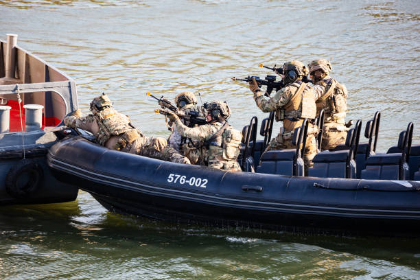 Szolnok, Hungary - August 18, 2022: Hungarian Defence Forces. Spec Ops soldier with carbine. Counter terrorism. Military unit. Special operation on the water with boat.