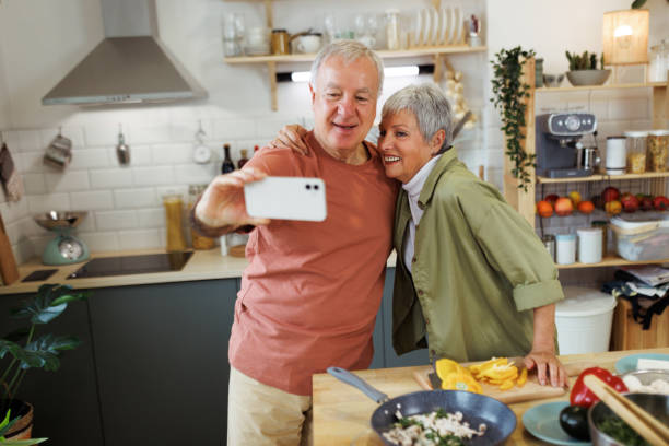 istock Senior couple taking selfie on smartphone at home 1482871323