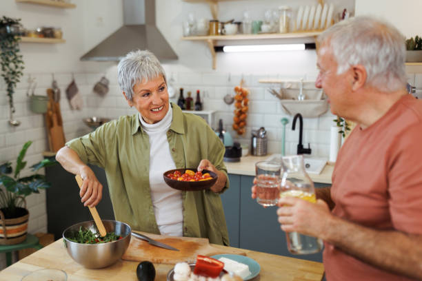 istock Senior couple making healthy salad in a kitchen 1482872041