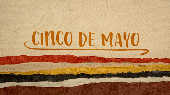 Cinco de Mayo, Fifth of May, more popular in the United States than Mexico, this holiday has become associated with the celebration of Mexican-American culture, note against abstract paper landscape