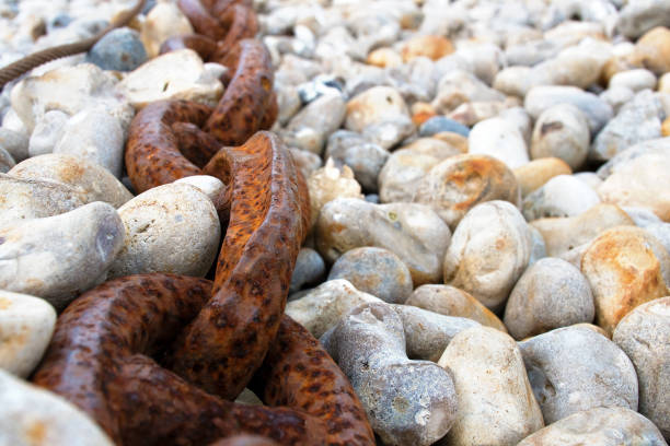 Thick, rusty chain on the shingle beach in Yport, Seine-Maritime, Côte d' Albatre, Normandie
