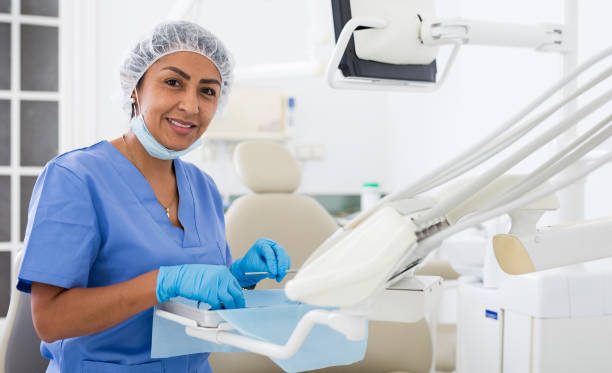 istock Smiling woman dentist preparing tools at dental office 1482876187