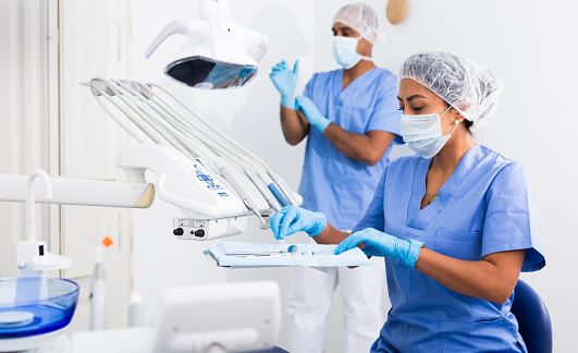 Doctors assistant prepares the dentists workplace for work