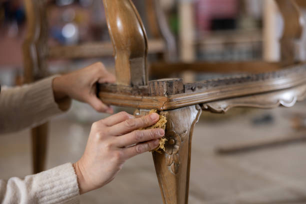 istock Close up of carpenter using rag while applying protective varnish to piece of wood 1482876355