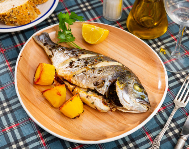 istock Grilled dorada with baked potatoes, lemon and parsley 1482877172