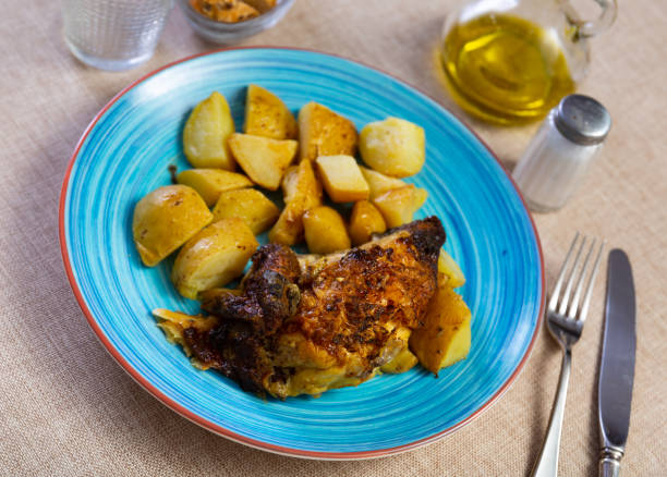 istock Tasty roasted chicken thigh served with boiled potatoes 1482877207
