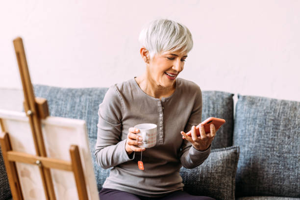 istock A Happy Beautiful Woman Using Her Mobile Phone While Relaxing At Home 1482877380