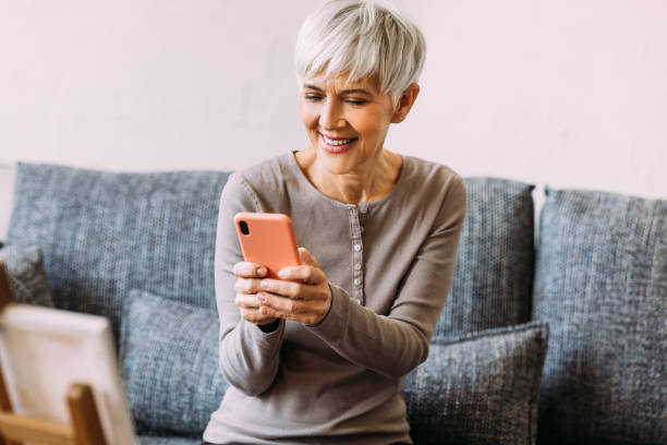 istock A Happy Beautiful Businesswoman Using Her Mobile Phone While Relaxing At Home 1482877381