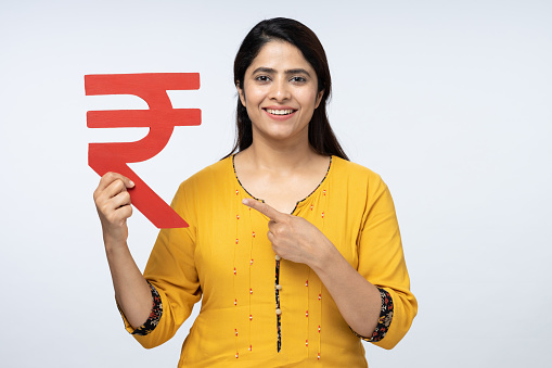 Portrait of young woman showing Rupee sign in isolated white background