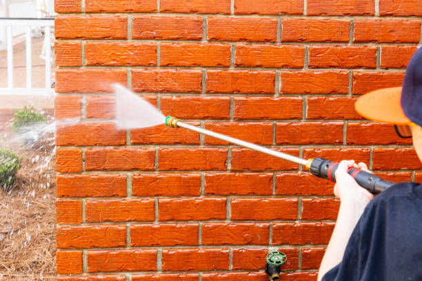 istock Pressure washer using water to clean a dirty brick wall on a house. 1482880553