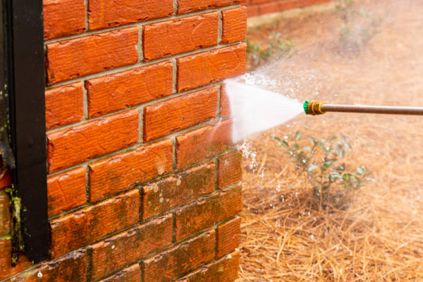 istock Dirty brick wall being cleaned with a pressure washer. 1482880623