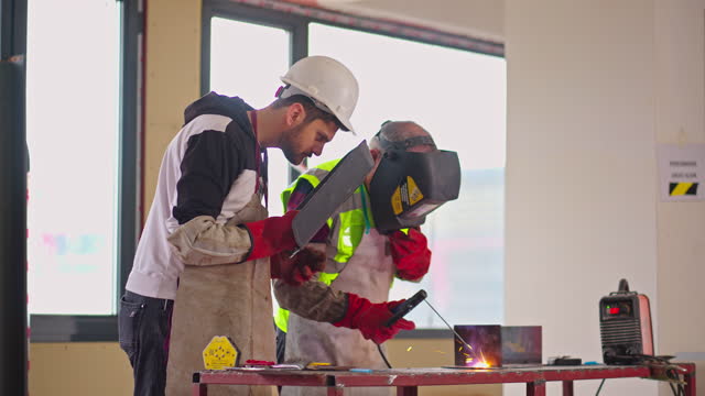 Young man Learning to Weld