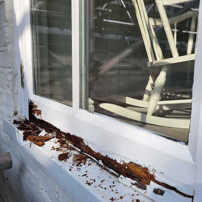 An old rotten window with white paint