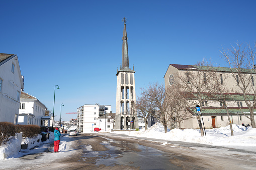 Mature woman on melting snow over traditional street in front Bodo Cathedral, Norther Norway.

iStock
Bodo Cathedral In Nordland County