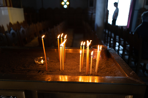 Candles burn in an orthodox church
