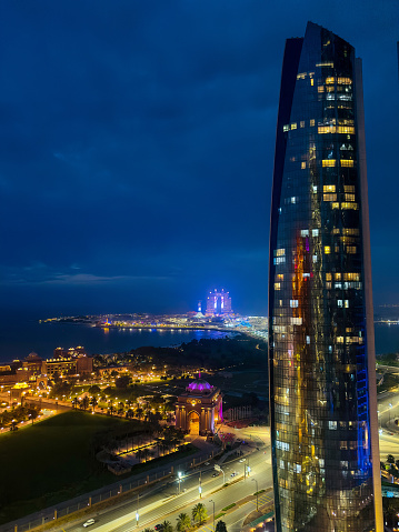 Modern skyline of Abu Dhabi downtown cityscape waterfront view in the United Arab Emirates at night at the UAE capital