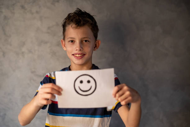 istock the boy is holding a happy smiley face 1482885934