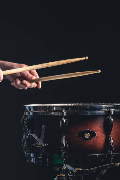 istock A man plays the snare drum against a dark background. 1482886078