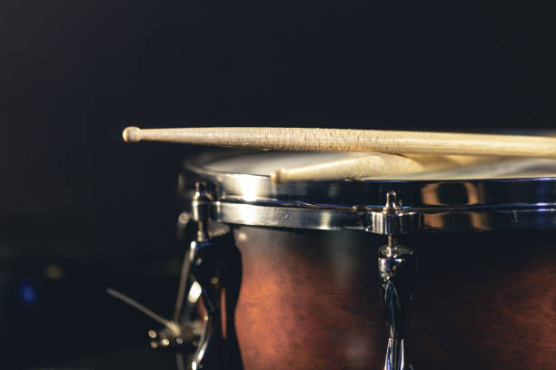 istock Close-up, snare drum and drumsticks on a dark background. 1482886200
