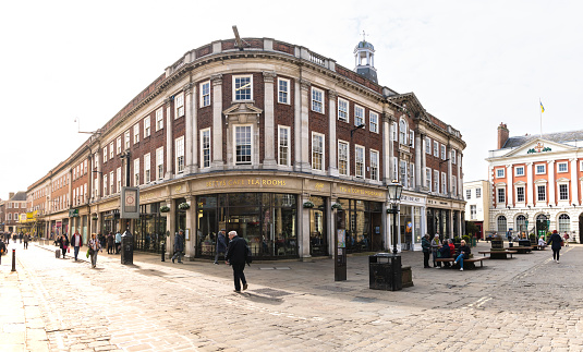 St Helens Square, York, UK - April 17, 2023. The exterior of the Bettys cafe and Tea Rooms building next to the ancient architecture of York Mansion House in York city centre