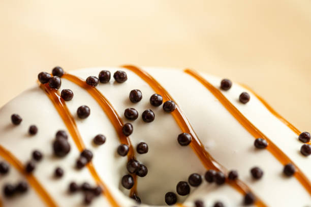 istock Appetizing donut covered with caramel and crispy balls, macro shot. 1482887367