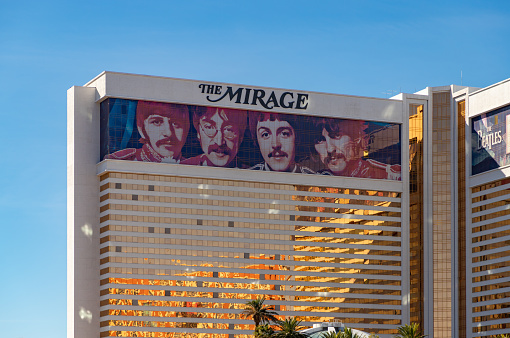 Las Vegas, United States - November 24, 2022: A picture of the Mirage with a large ad of the show Love by Cirque du Soleil, about the Beatles, on its facade.