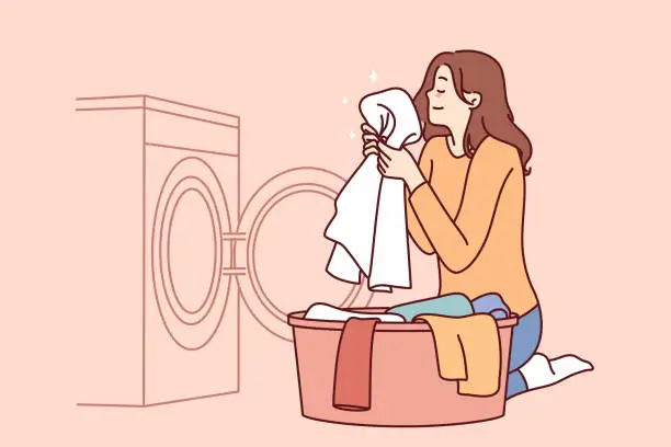 Vector illustration of Housewife woman sits near washing machine and inhales fragrant smell of freshly washed towel