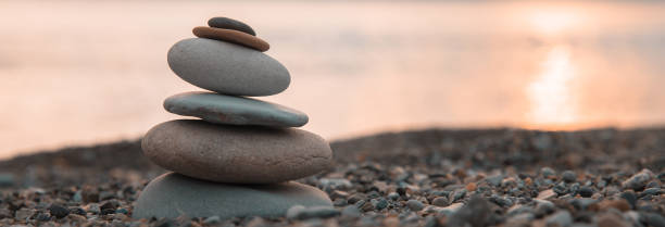 istock Zen stones on sunset background 1482892095