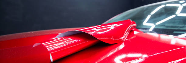 istock Car wrapping, squeegee installs film 1482892126
