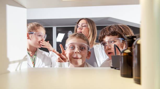 istock Diverse schoolchildren with teacher work together on science project 1482897236