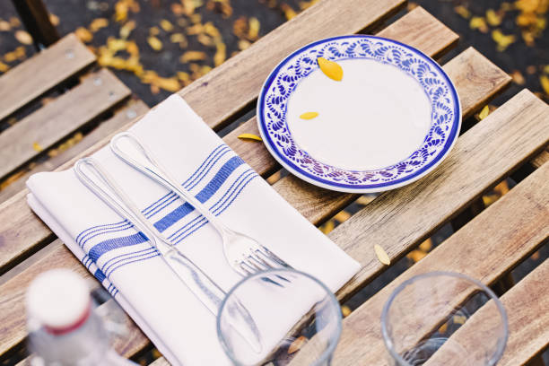 istock Street cafe table setting with yellow leaves fallen from the tree 1482898565