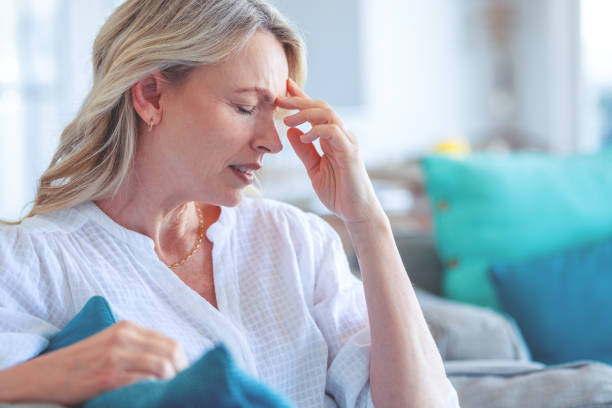 istock Upset stressed mature woman sitting on the sofa. 1482899586