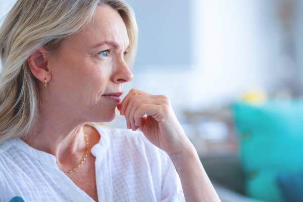 istock Upset stressed mature woman sitting on the sofa. 1482899616