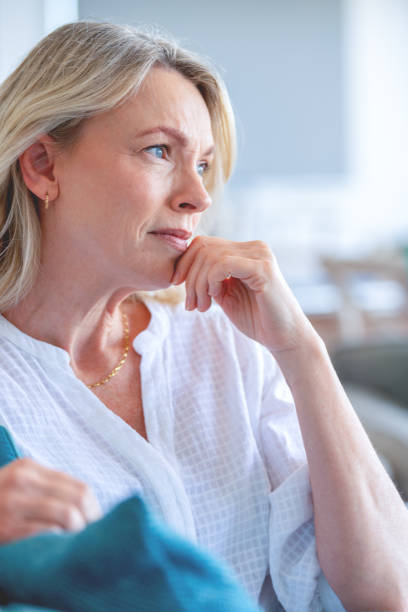 istock Upset stressed mature woman sitting on the sofa. 1482900916