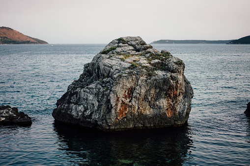 A stunningly large rock formation protruding from the waters of Herceg Novi, Montenegro