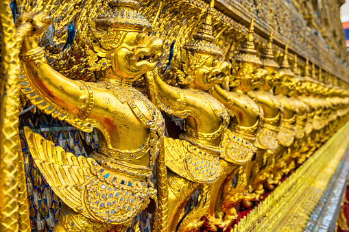 The Ubosot (Ordination Hall) at Wat Phra Kaew temple, Grand Palace, Bangkok. It is decorated with a golden row of 112 Garudas (demigods).