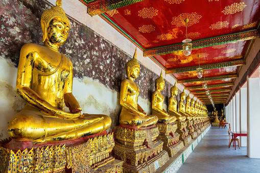Buddha statues in a row at Wat Suthat Thepwararam in Bangkok, Thailand