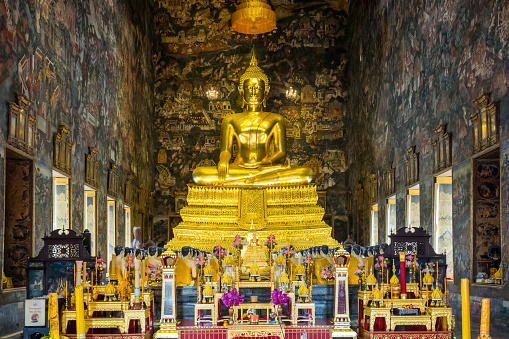 Buddha Statue inside Phra Ubosot (Ordination Hall) at Wat Suthat in Bangkok, Thailand.