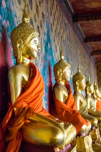 Row of Buddha statues at Wat Arun temple in Bangkok, Thailand.