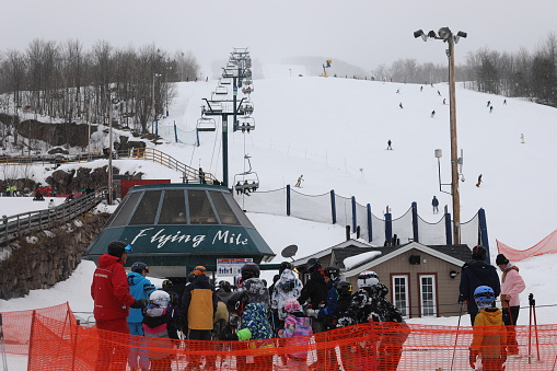 March 14, 2023 - Mont-Treblant, Quebec, Canada: People skiing and snowboarding at Mont-Treblant Ski Resort in Quebec, Canada. March Break in Mont-Treblant. Skiing and snowboarding in Quebec, Canada. Mont-Treblant Ski Resort in March 2023.