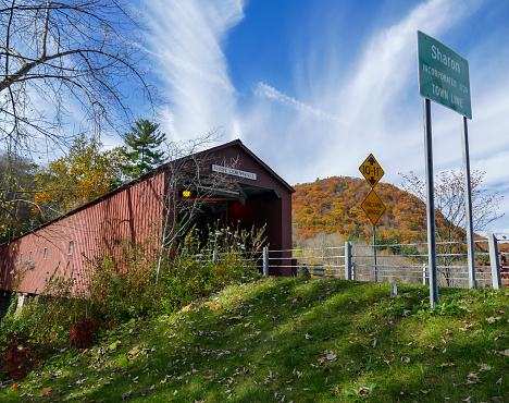 West Corrnwall, CT, USA - OCTOBER 26, 2019. The 1864 West Cornwall Covered Bridge. also known as Hart Bridge, is a wooden lattice truss bridge over the Housatonic River.