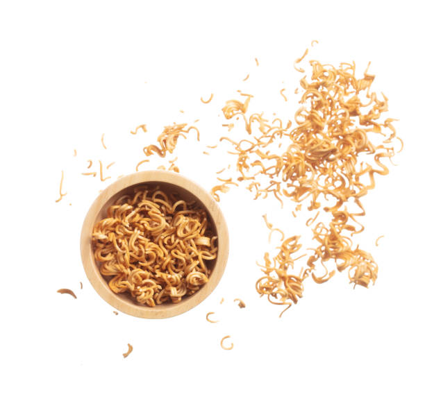 istock Instant Noodle fly in wooden bowl, yellow instant noodle float explode, abstract cloud fly. Curved dried instant noodles splash throwing in Air. White background Isolated high speed shutter 1482931050
