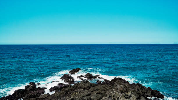 istock Blue sky and summer sea with rocky wave foam 1482934762